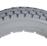 Close-up of a 12-1/2 x 2-1/4 Solid Gray Polyurethane Wheelchair Tire featuring a durable, knobby tread design for indoor and outdoor use, offering flat-free and latex-free reliability.