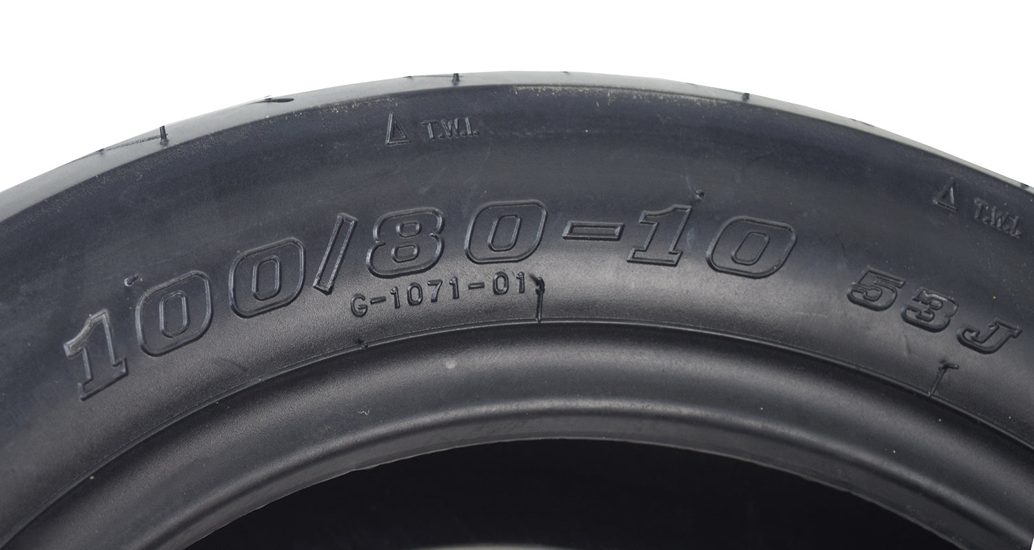 Close-up of the 100/80-10 Tubeless Pneumatic Front Tire for the Drive Medical King Cobra Mobility Scooter, showcasing its shallow street tread design ideal for smooth rides on hard surfaces.