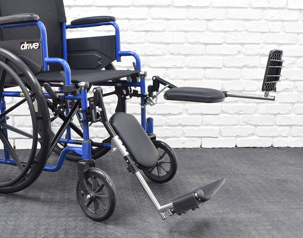 Drive Medical Style Elevating Footrest & Leg Rest Assembly (Set of 2) shown attached to a wheelchair, featuring height-adjustable leg rests and removable heel loops.