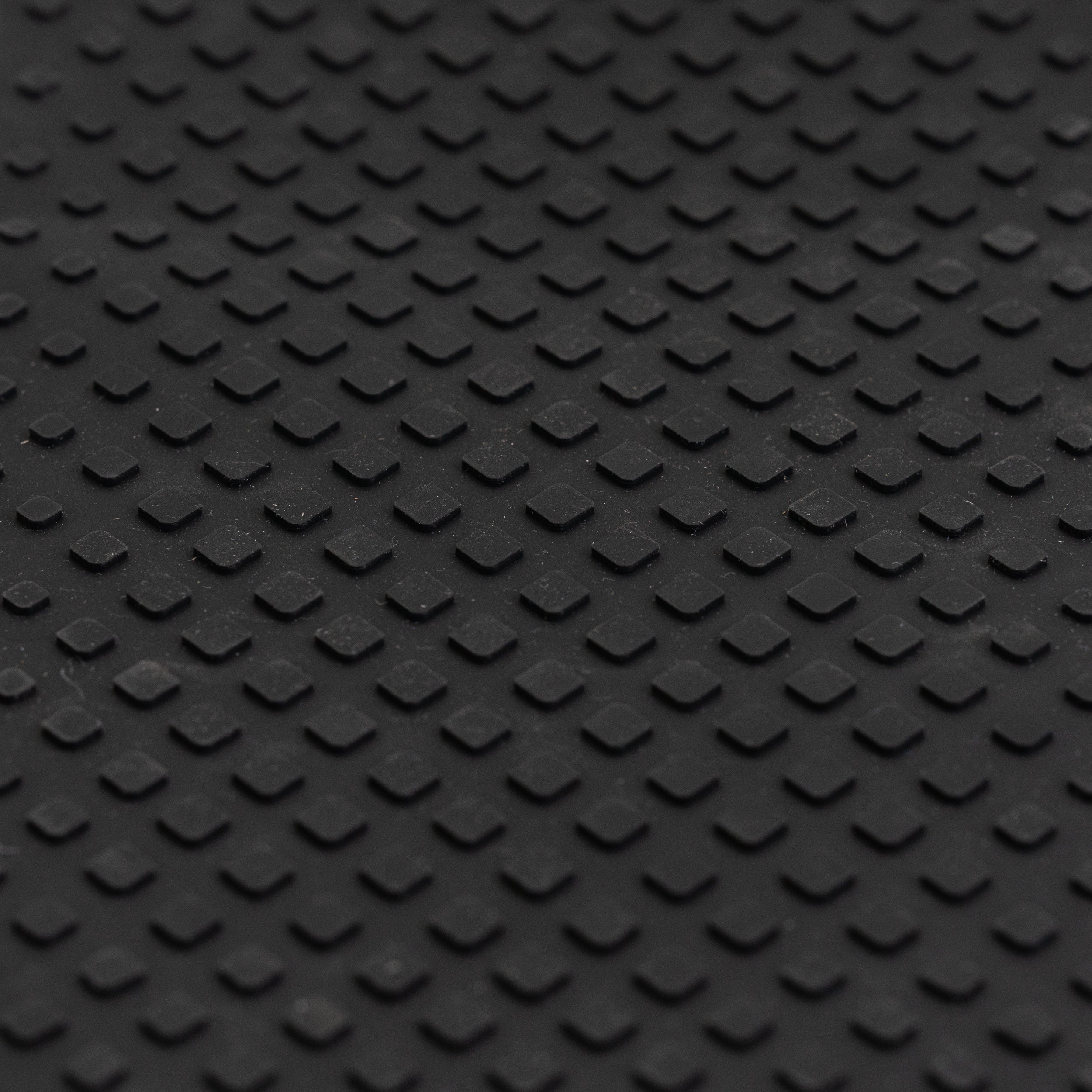 Close-up view of a textured nonslip black rubber Footmat for Ninebot by Segway ES1 & ESB Electric Scooters, designed to rejuvenate the deck frame with peel-and-stick adhesive.