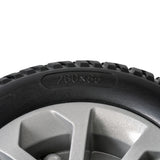 Close-up of the 3.00-4 (10x3) Black Flat Free Drive Wheel for the Golden Compass Sport power chair, featuring a solid black tire and a silver rim, suitable for newer models.