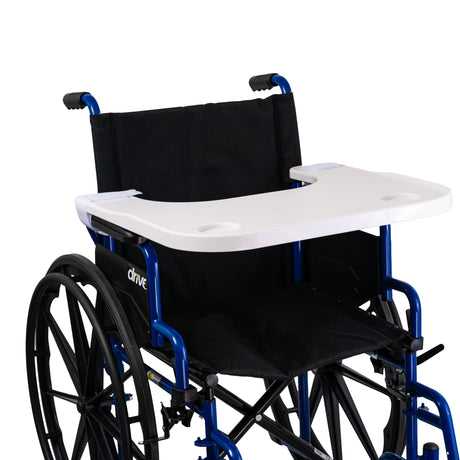 Plastic Tray Table for Wheelchairs: A sturdy ABS plastic tray with a built-in cup holder, attached to a wheelchair via velcro straps, providing a versatile surface for various daily activities.