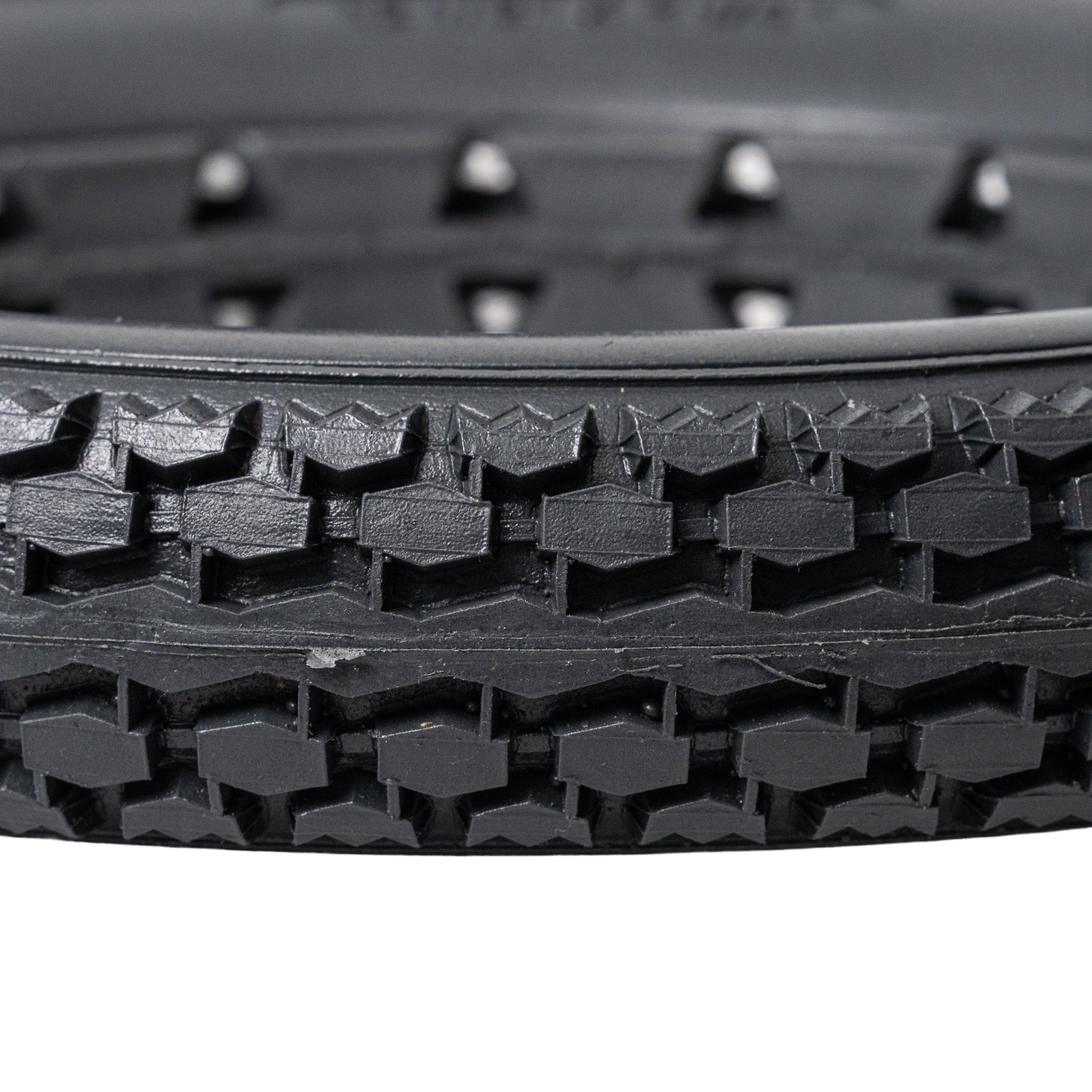 Close-up of the 12-1/2x2-1/4 Dark Gray Solid Urethane Mobility Tire with Knobby Tread, highlighting its robust, flat-free design suitable for both indoor and outdoor use.