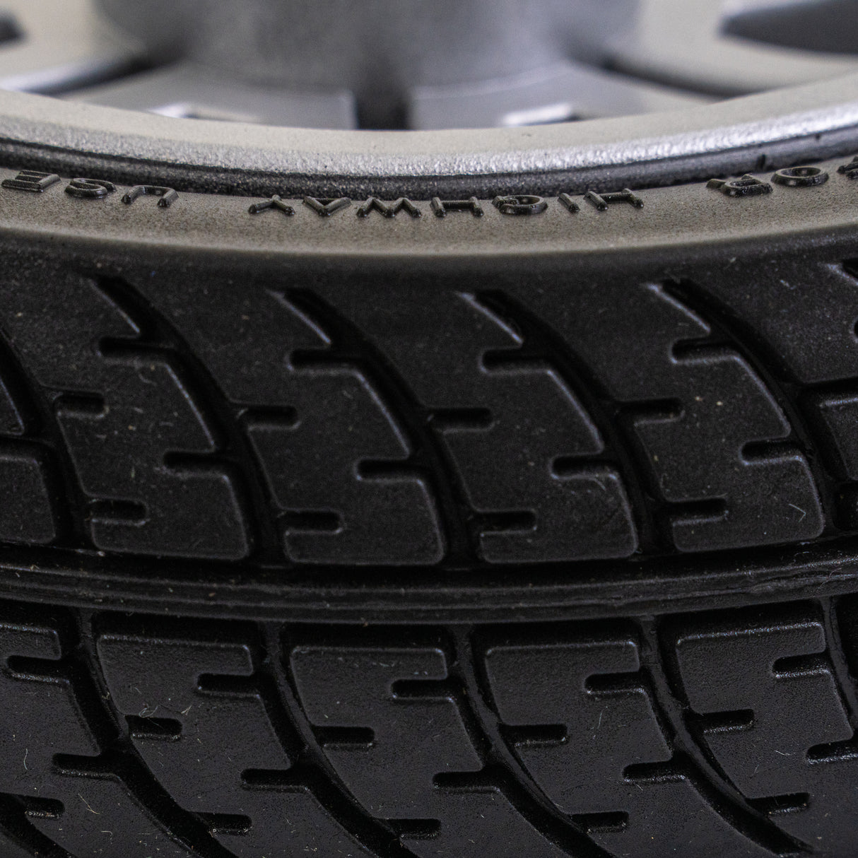 Close-up of a Drive Scout DST 3 & 4 8x2 flat-free rear wheel assembly, showcasing the solid rubber tire tread designed for mobility scooters.