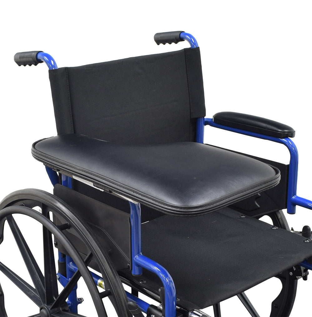 Universal Padded Black Vinyl Half-Lap Flip-Up Tray mounted on a wheelchair with a black cushioned seat and armrests, showcasing its convenient attachment and functionality.