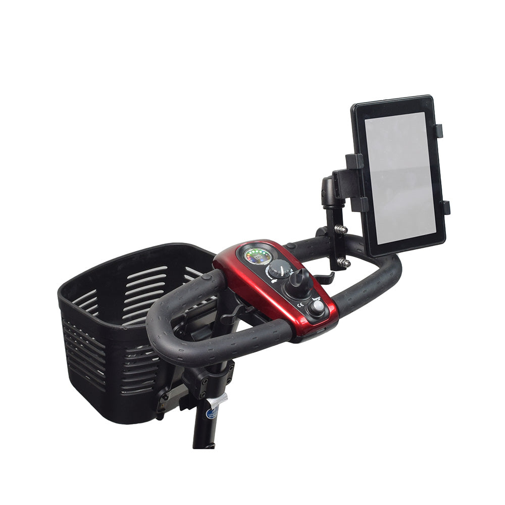 Universal Grip Tablet Holder for Mobility Scooters, Power Chairs, & Wheelchairs, shown mounted on bicycle handlebars with a tablet securely held by adjustable wings, and a black basket visible below.