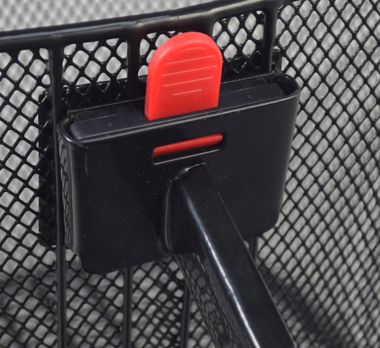 Premium Universal Wire Basket for Bicycles & Scooters (Missing Hardware) attached to a bike with a quick-release red lock and black mesh design, featuring a handy loop handle for easy carrying.