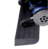 Close-up of a wheelchair wheel, emphasizing the durable, slip-resistant rubber material of EZ Edge Threshold Ramps, designed for small barriers with sloped sides to prevent caster trapping.