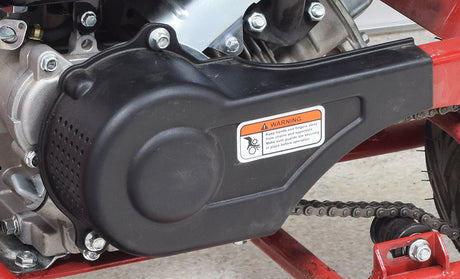 Plastic Clutch Cover for Coleman CC100X & CT100U Mini Bikes mounted on a motorcycle, showcasing close-up metal parts and a visible warning label.