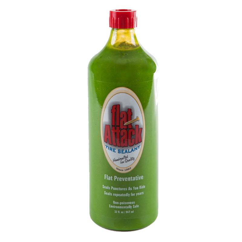 Flat Attack Tire Sealant - 32 oz Bottle, shown as a clear glass bottle filled with green liquid, designed for environmentally friendly tire maintenance, preventing valve and pump clogs, suitable for tubed or tubeless tires.