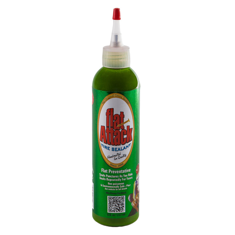 Flat Attack Tire Sealant - 8 oz Bottle, featuring a sleek design with a red cap, is shown in close-up. This eco-friendly sealant ensures hassle-free installation and maintenance for both tubed and tubeless tires.