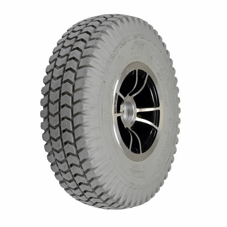 Foam-Filled Drive Wheel Assembly for Rascal 312 featuring a tire with a silver split-rim and knobby tread.