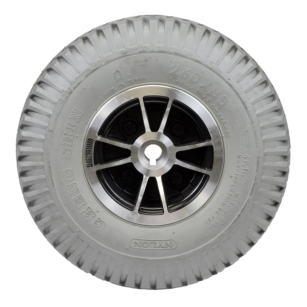 Foam-Filled Drive Wheel Assembly for Rascal 312 featuring a close-up of a silver rim and knobby tread tire, fully assembled for easy conversion from pneumatic to durable foam-filled design.