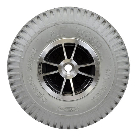 Foam-Filled Drive Wheel Assembly for Rascal 312 featuring a close-up of a silver rim and knobby tread tire, fully assembled for easy conversion from pneumatic to durable foam-filled design.