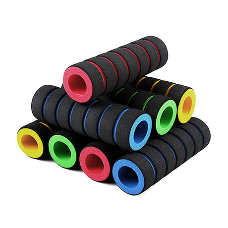 A stack of Foam Bike & Scooter Handlebar Grip Sets, featuring soft, spongy black grips with different colored circles, designed for various handlebars and providing cushioning for long rides.