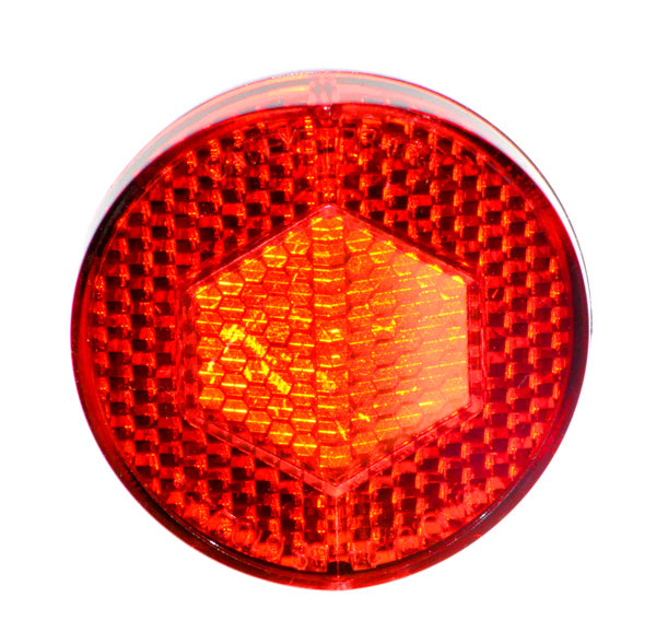 Rear Round Reflector for Currie Scooters, featuring a hexagon pattern design, mounts on the kick plate's rear with a screw. Suitable for models from 2006 onwards and retro-fittable for earlier versions.