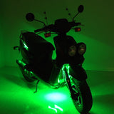 Multi-Color LED Light Kit for Street Scooters, shown illuminating a scooter with green lights, highlighting its vibrant, customizable glow for enhanced visibility and style.