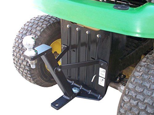 Close-up of the Lawn-Pro Hi-Hitch Lawn Mower Trailer Hitch installed on a tractor, highlighting its durable aluminum build and dual attachment points for trailer hitch ball and hitch pin.