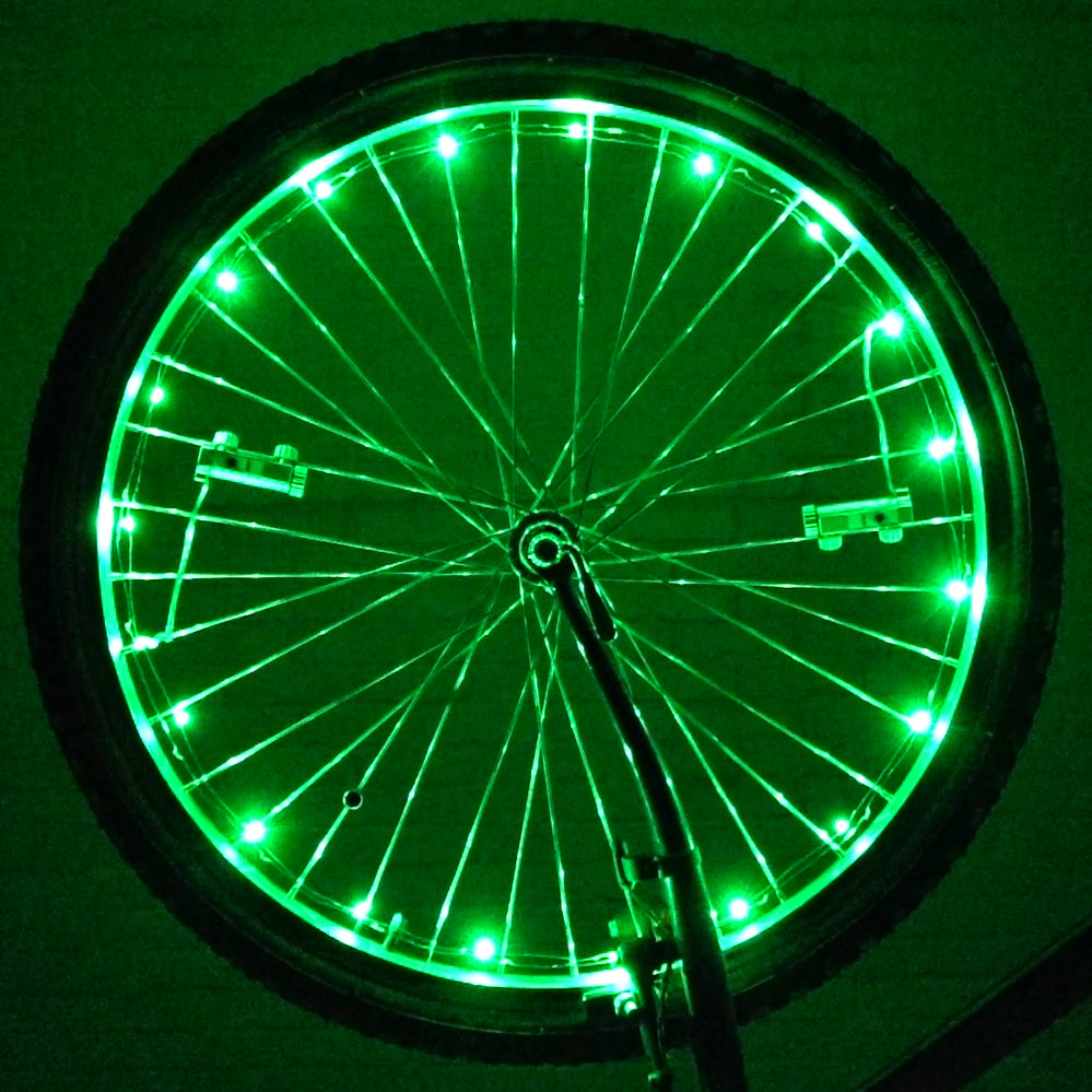 LED Bicycle Rim Spoke String Lights: A bicycle wheel adorned with green LED lights, enhancing visibility and style. The lights are wrapped around the spokes, creating a vibrant, illuminated effect.