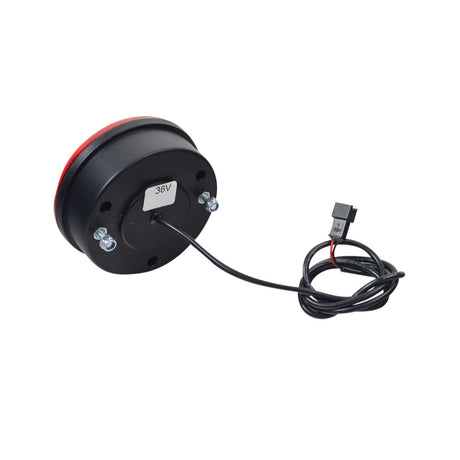 Taillight for the Razor Rambler 16 Electric Mini Bike, a 3-1/2 diameter round black object with a wire, featuring a white sticker with black numbers and a cable connection.