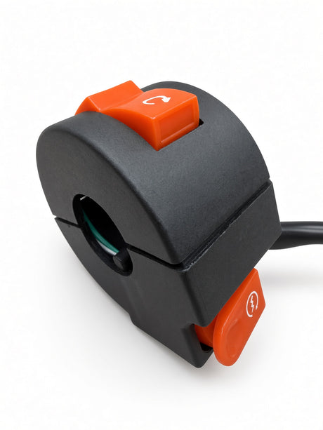 A black plastic electrical switch module with two bright orange toggle buttons, one featuring a curved arrow symbol and the other a lightning bolt symbol, shown on a white background.