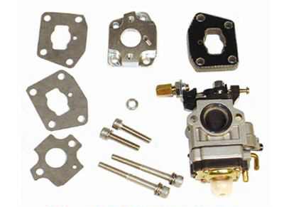 High Performance 15 mm Carburetor Kit by Tanaka - 40cc, shown in a close-up of mechanical parts including the carburetor with visible holes, manifold, gaskets, and hardware.