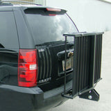 Folding Mighty Lite Aluminum Scooter and Power Chair Carrier attached to the back of a black vehicle, featuring a hitch-receiver and bike rack, with a close-up of the license plate and taillight.