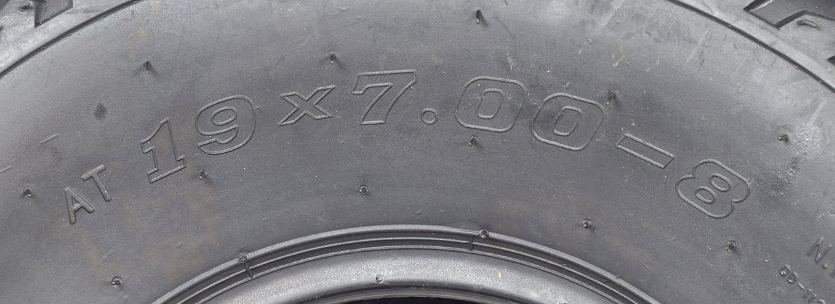 Close-up of 19x7.00-8 Tire with QD112 Knobby Tread for Baja Mini Bikes MB165 & MB200, ATVs, & Go Karts, showcasing detailed tread pattern and sidewall markings.