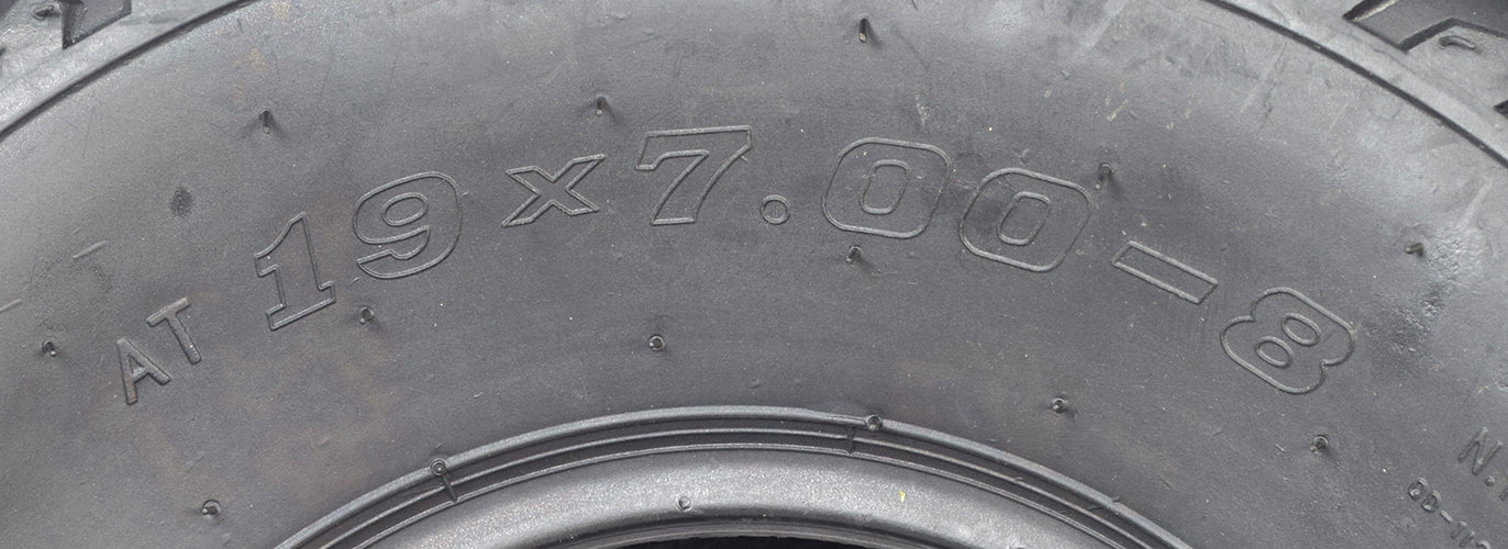 Close-up of the 19x7.00-8 V-Tread Tire for the Monster Moto / Mega Moto MM-B212 Mini Bike, highlighting the aggressive V-tread pattern designed for superior off-road performance.