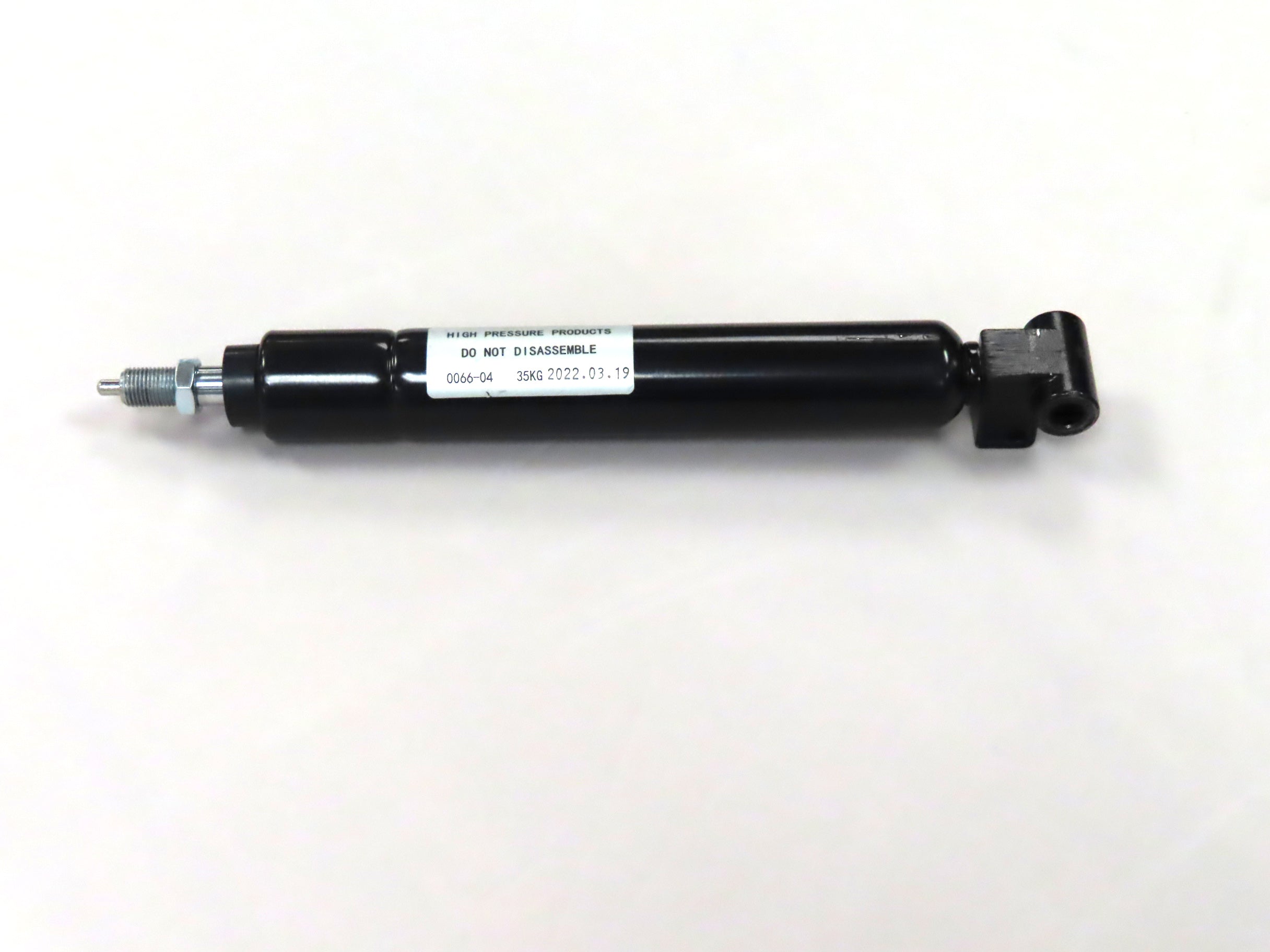 Tiller Gas Shock Assembly for the Golden Technologies Companion I & II (GC221/321/421) (Blemished) – close-up of a black cylinder with a white label, designed to dampen vibrations in mobility scooters.