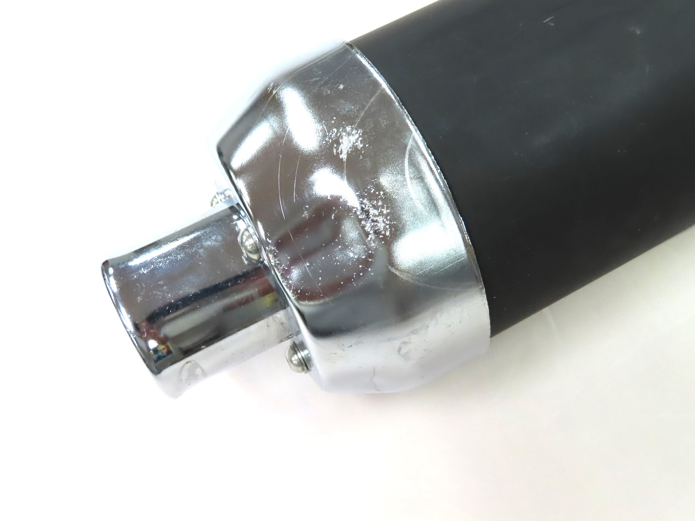 Muffler for 150cc Go-Karts (Blemished) - close-up of a black and silver cylindrical pipe with a shiny metal surface and visible screw details.