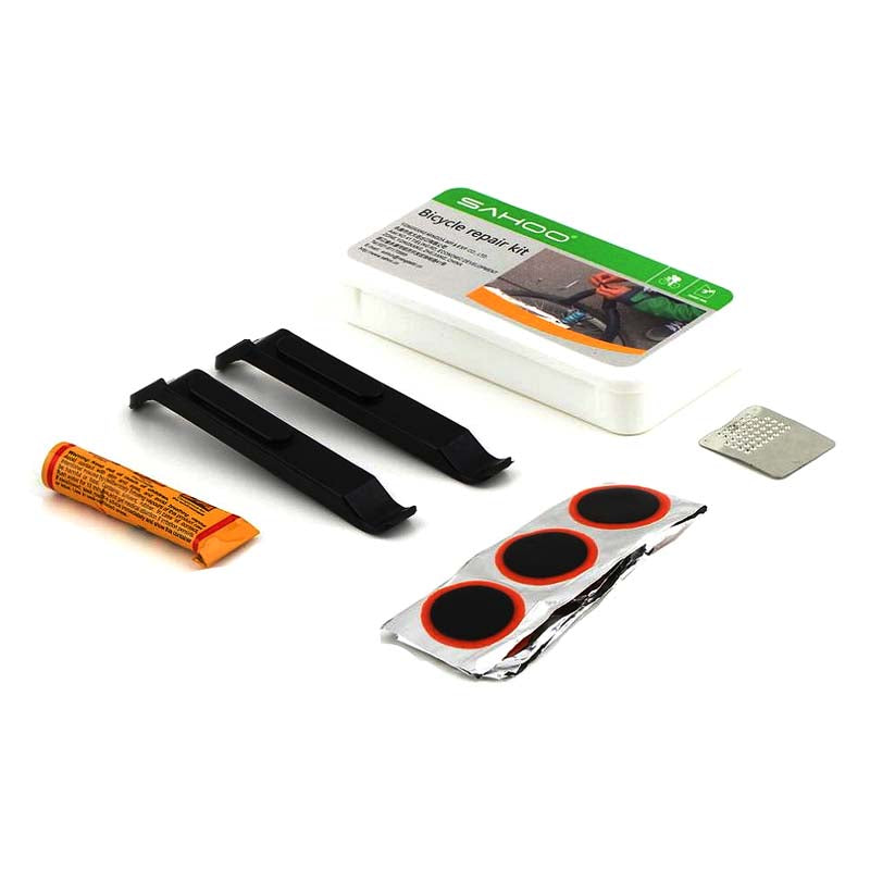 Inner Tube Patch & Repair Kit featuring eight rubber patches, two tire levers, a tube of rubber cement, and a perforated metal rasp for fixing punctured inner tubes on bikes or scooters.