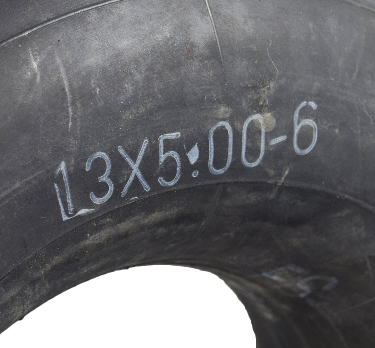 Close-up of a 13x5.00-6 inner tube with angled valve stem, compatible with TaoTao EK80 & GK80 go-karts. The tire displays numbers and writing, indicating its specifications.