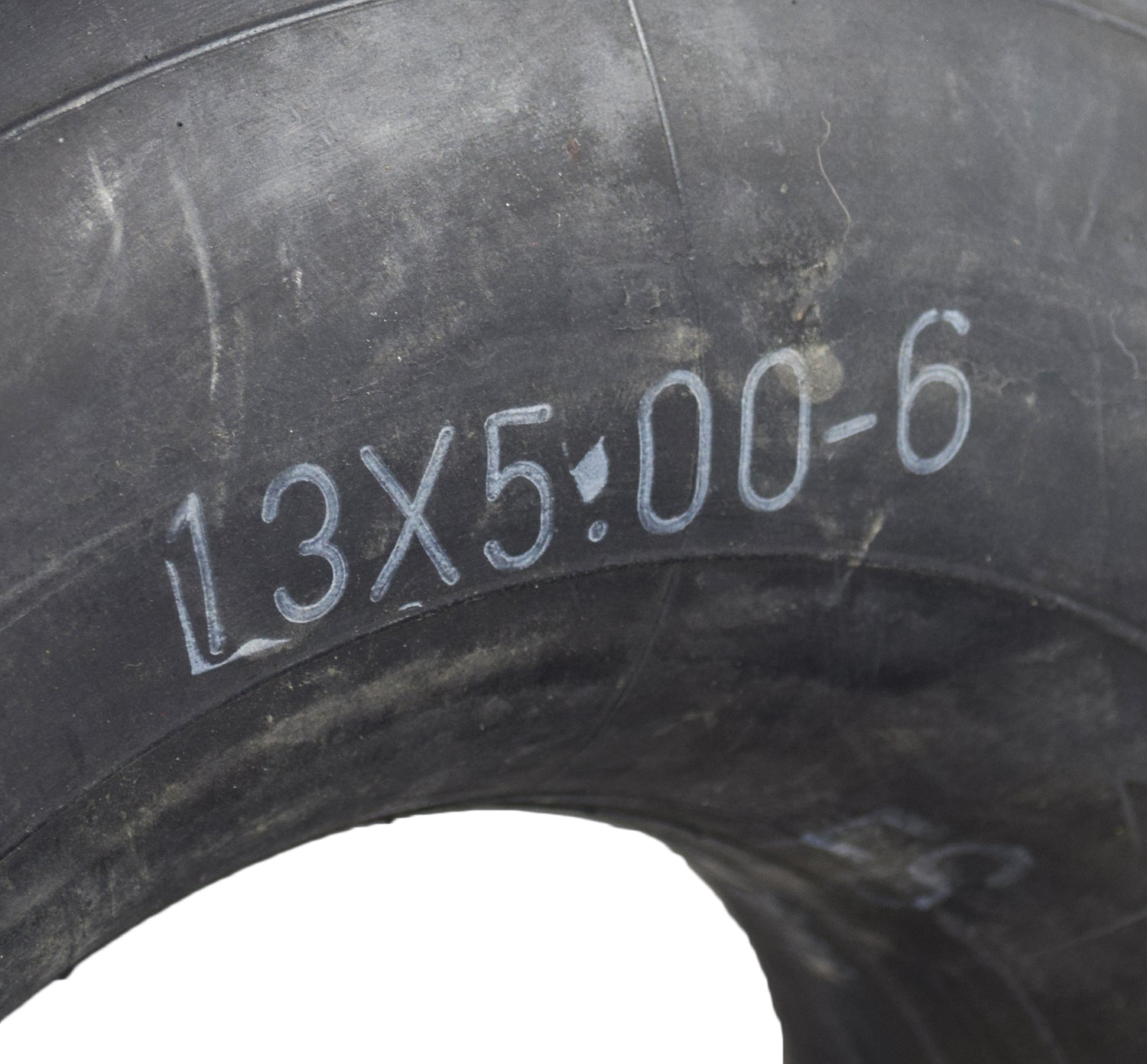 Close-up of a 13x5.00-6 Inner Tube with Angled Valve Stem for the MotoTec MT-ATV Mini Quad, showing tire details and part of the angled valve stem.