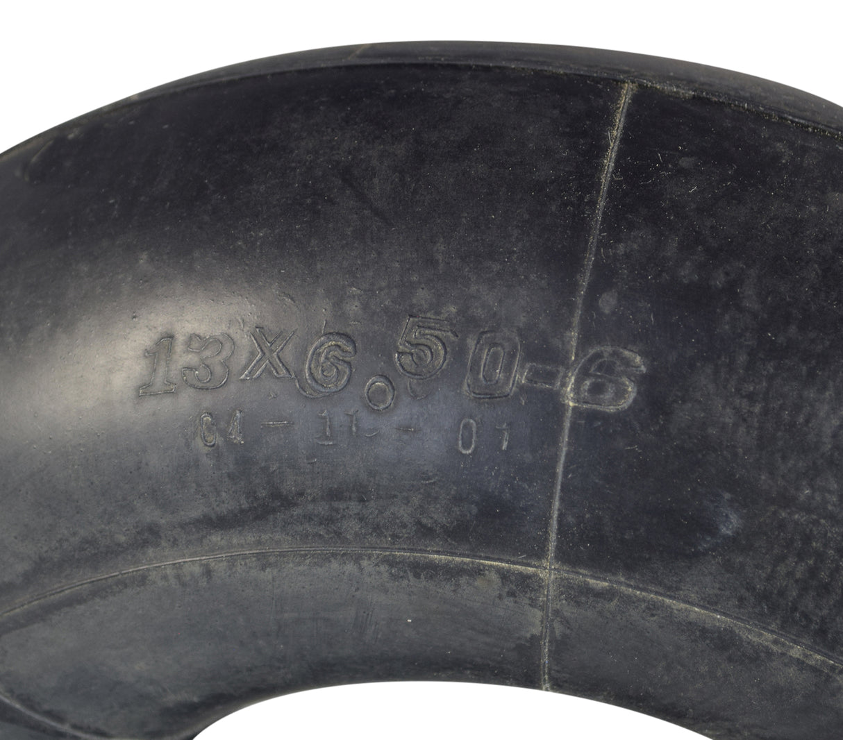 13x6.50-6 Black Pneumatic Mobility Tire with knobby tread pattern, commonly used on Pride Wrangler 4-wheel scooters. Tire shown close-up with writing on it.