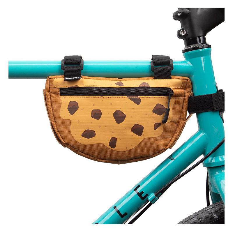 Cookie Frame Bag for Bikes attached to a bicycle frame with three Velcro straps, showcasing a sturdy design and ample 60 cubic inches storage space, ideal for carrying essentials on rough trails.