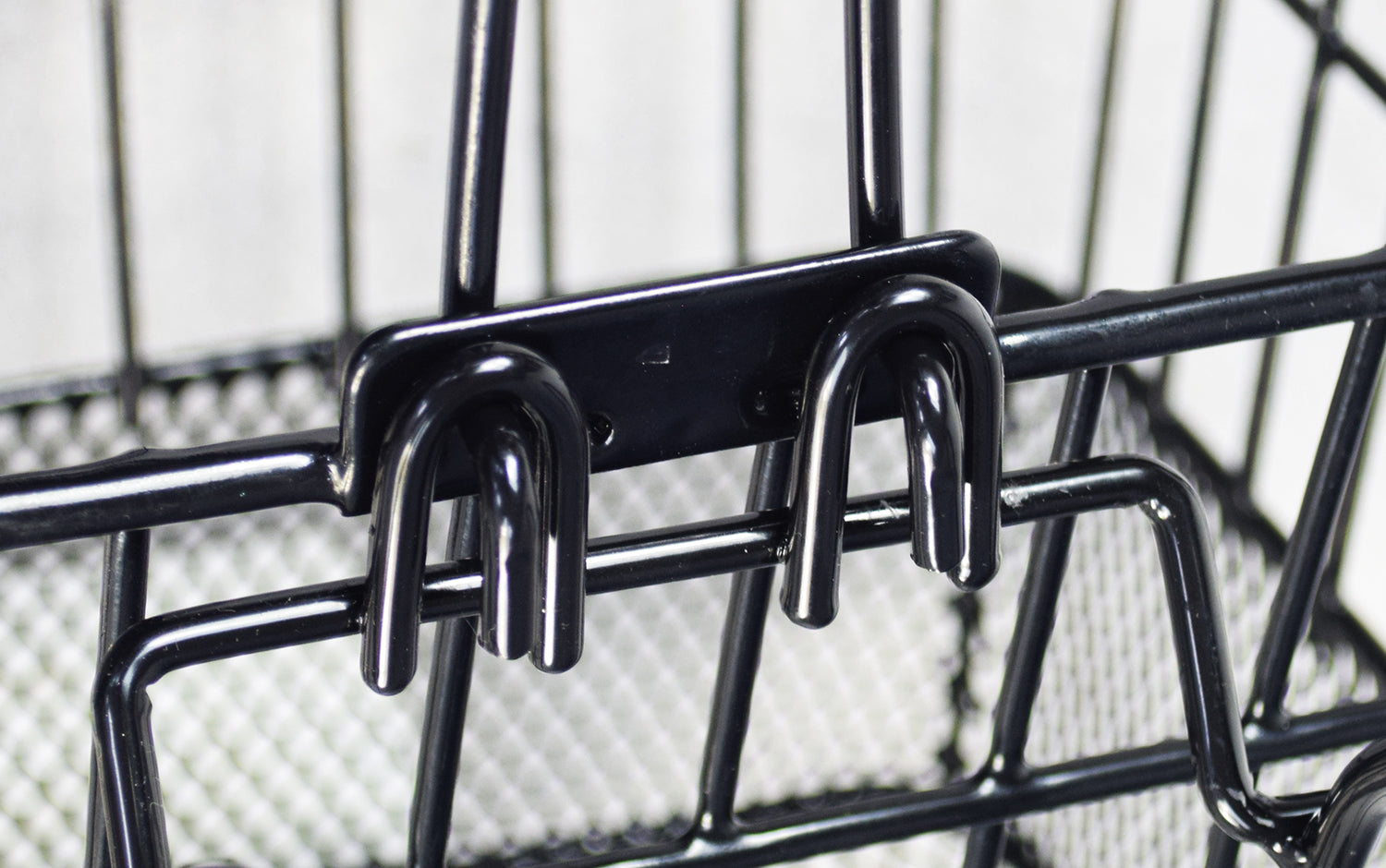 Close-up of the Lift-Off Wire Basket with Mesh Bottom (Blemished) featuring a sturdy black metal hook and wire construction, ideal for bikes or scooters.