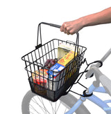 Hand holding a Lift-Off Wire Basket with Mesh Bottom, filled with groceries, attached to a bicycle.