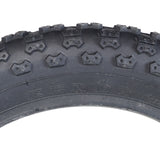 14x2.125 Black MX3 Bicycle Tire with K50 Tread, featuring a close-up of the black tire's detailed knobby tread pattern designed for enhanced grip and performance.