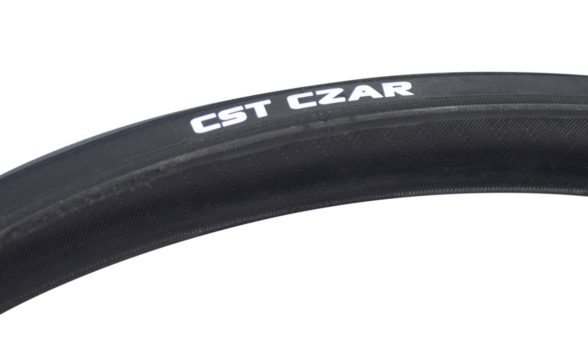 700x25 Czar Wire Bicycle Tire featuring a smooth center tread and grooved lateral patterns for traction, with visible white text on the black rubber surface.