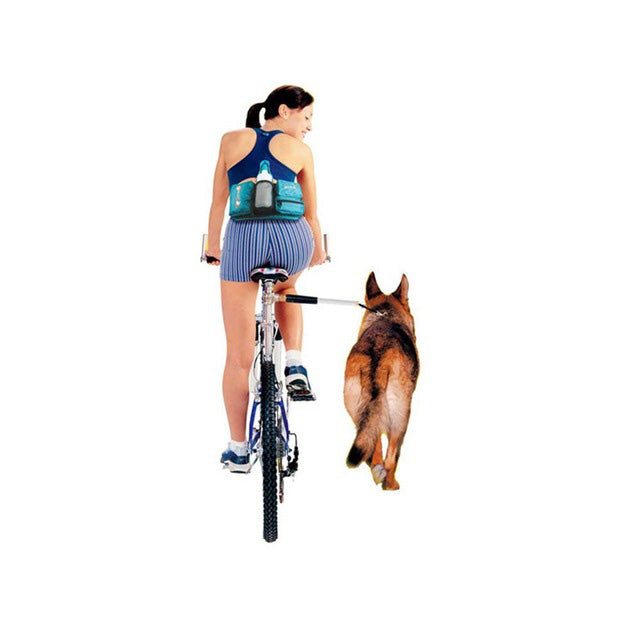 Woman riding a bike with a dog using the Hands Free Bicycle Dog Leash, which securely attaches the dog to the bike, ensuring safe and tangle-free exercise alongside the rider.