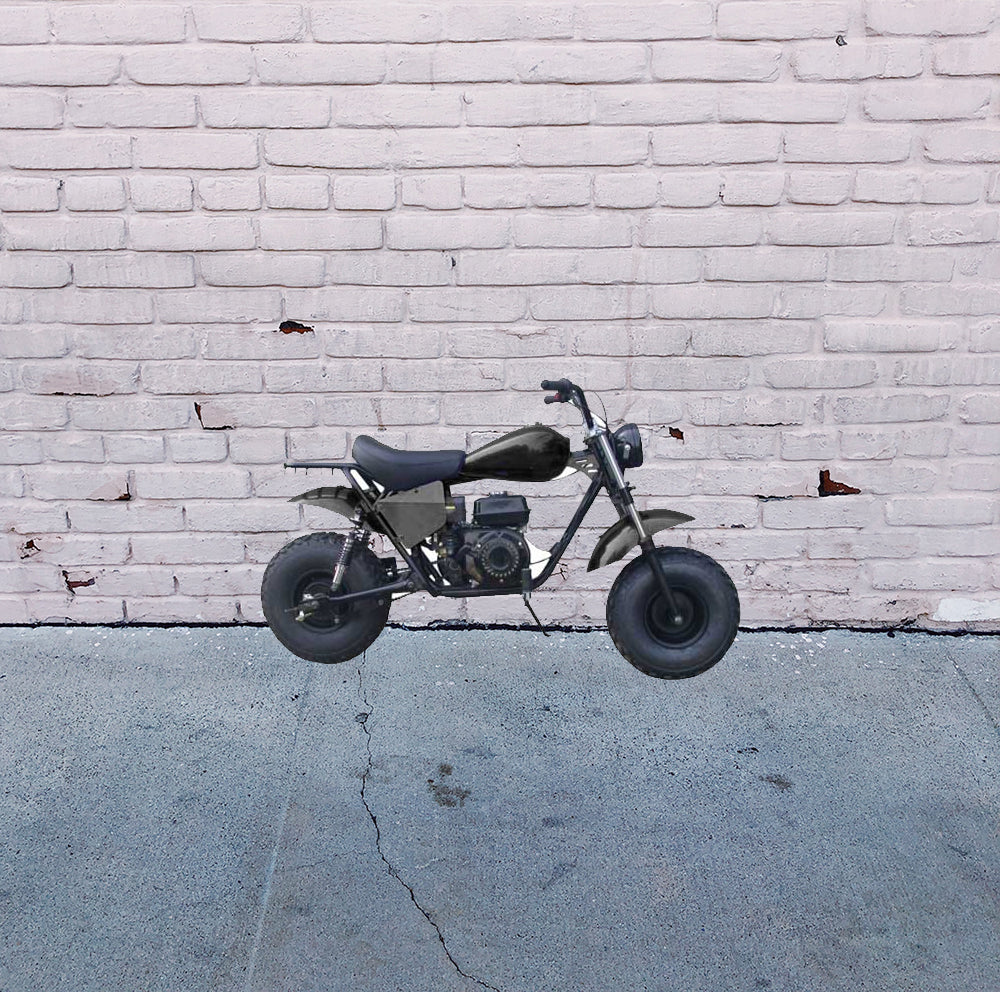 Black Seat for Baja Mini Bike MB165 & MB200 (Baja Heat, Mini Baja, Baja Warrior) (Blemished), displayed on a motorcycle in front of a white brick wall, highlighting the seat's contour and stitching.