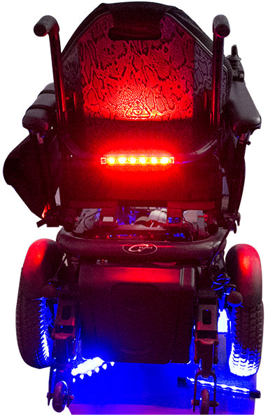 Light Kit for Mobility Scooters and Power Chairs featuring red and white LED lights attached to a wheelchair, enhancing safety and style with peel-and-stick backing and remote-controlled lighting modes.