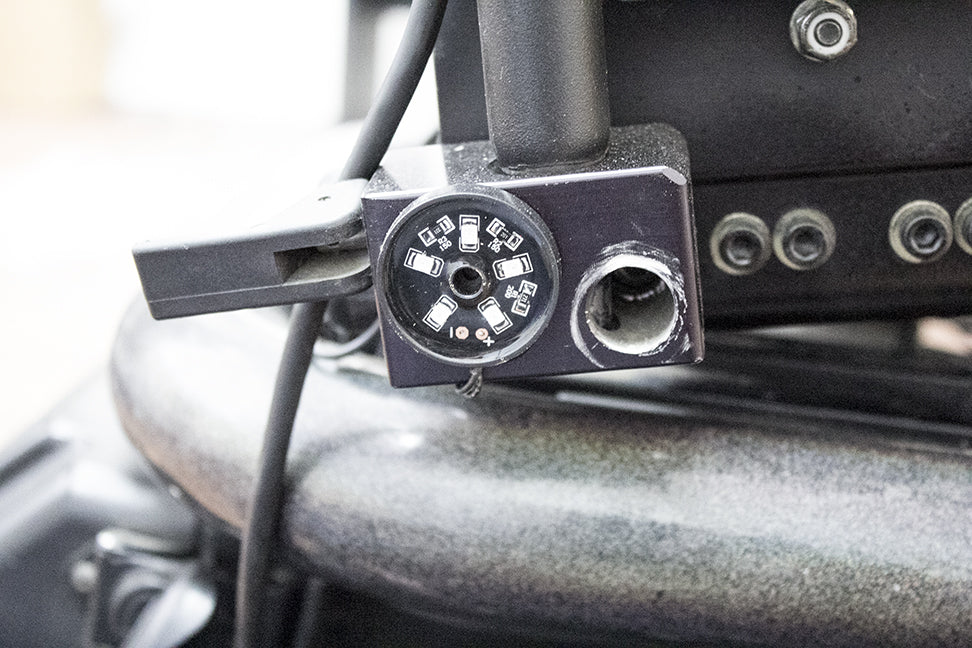 Close-up of the LK100 Power Chair Light Kit, showcasing a circular pod with a hole, part of the waterproof LED lighting set for mobility scooters and power chairs.