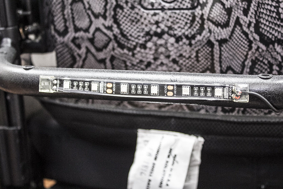 Close-up of the LK100 Power Chair Light Kit, showing a light bar with LEDs. This kit includes multiple light pods and strips for enhanced visibility and style on power chairs and scooters.