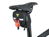 Redlite Mini USB Bicycle Taillight (Topeak) shown mounted on a bicycle seat, featuring three super-bright ruby red LEDs and a compact design with an easy-to-use rubber strap for tool-free fastening.