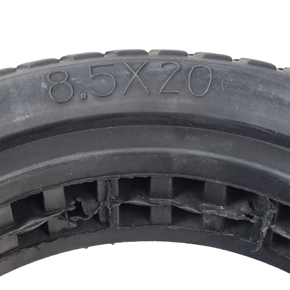 Close-up of the 8.5x20 Shock Absorber Solid Tire for the Xiaomi Mi M365, showcasing its detailed tread design and series of hollow rectangular chambers for improved ride comfort.