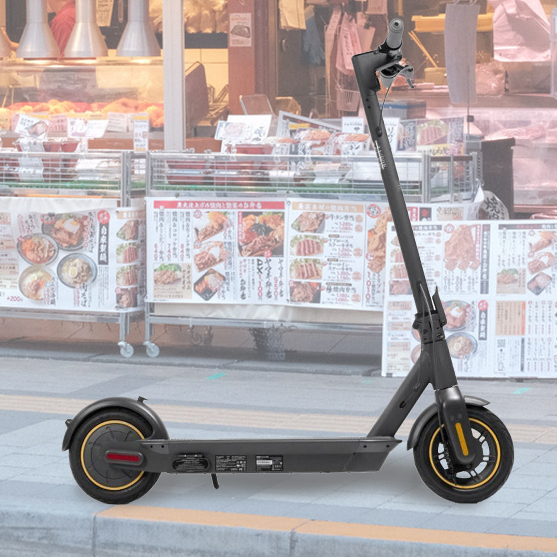 Front Wheel Assembly for the Ninebot MAX G30 Scooter displayed on a sidewalk, showcasing the wheel, tire, and rim in close-up detail.