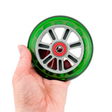 A hand holding one of the 98 mm Razor A Kick Scooter Wheels with Bearings (Set of 2), showcasing the green wheel's size and durable polyurethane material.