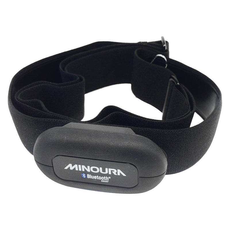 Minoura Bluetooth Heart Rate Monitor on a black strap, designed for cyclists to display heart rate data on smartphones. The close-up shows the Bluetooth device attached to the strap.